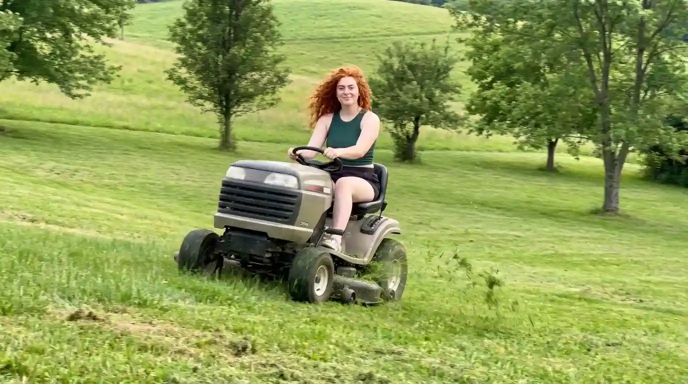 Driving a garden tractor across a sloped lawn on a large property